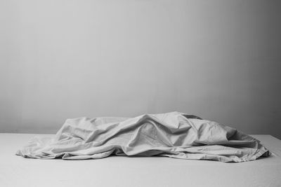 Lounge chair on bed against wall