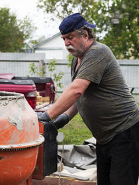 Side view of man holding umbrella