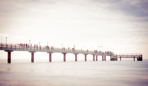 Pier over sea against sky