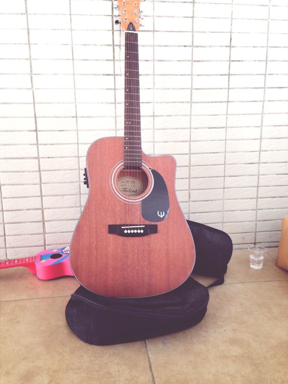 indoors, technology, music, guitar, musical instrument, arts culture and entertainment, still life, communication, close-up, string instrument, metal, musical equipment, musical instrument string, wall - building feature, equipment, chair, no people, modern, table, absence