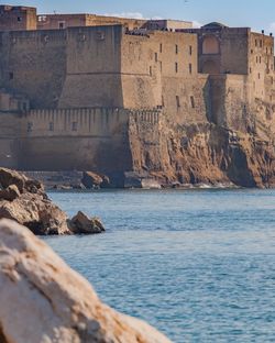 Castle by sea against sky