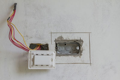 Close-up of broken electrical component on wall