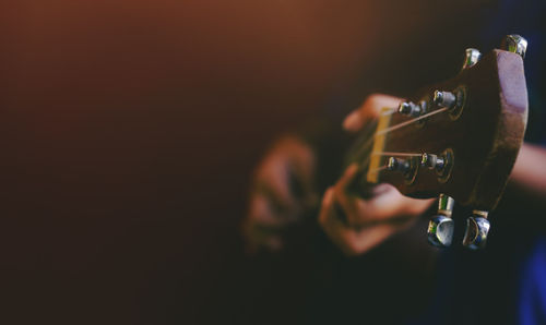 Close-up of hand playing guitar