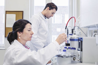 Male and female scientists working at laboratory