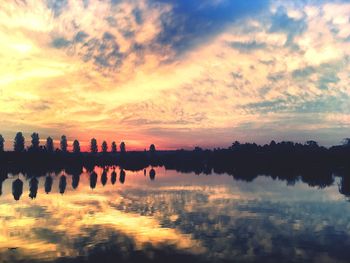 Reflection of clouds in sea at sunset