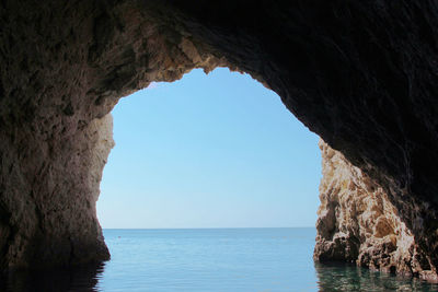 Scenic view of sea seen through cave