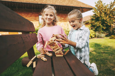 Happy girl holding umbrella on wood