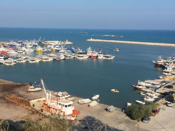 High angle view of harbor by sea against sky