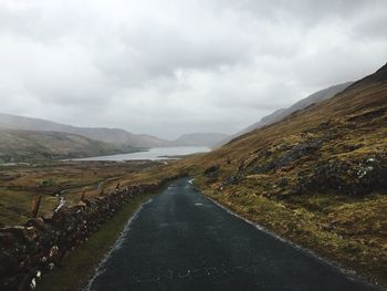 Empty road along countryside landscape