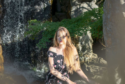 Full length portrait of woman standing in water