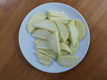 High angle view of chopped fruits in plate on table