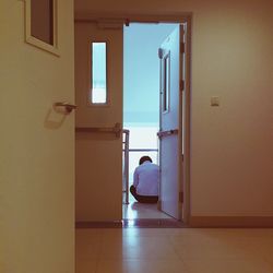 Rear view of man in corridor