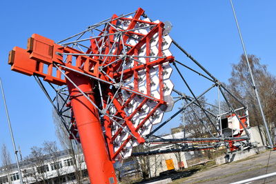 Low angle view of construction site against clear blue sky