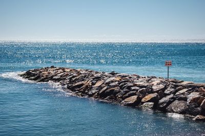 Scenic view of sea against blue sky