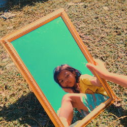 High angle portrait of happy girl holding plants