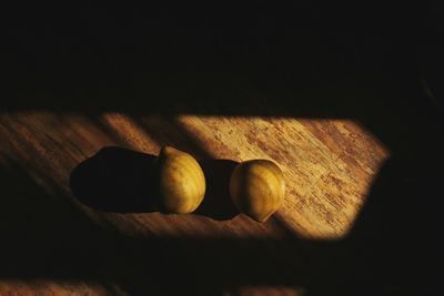 High angle view of two lemons on a wooden floor