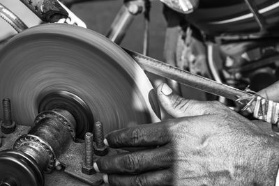 Close-up of man working on machine