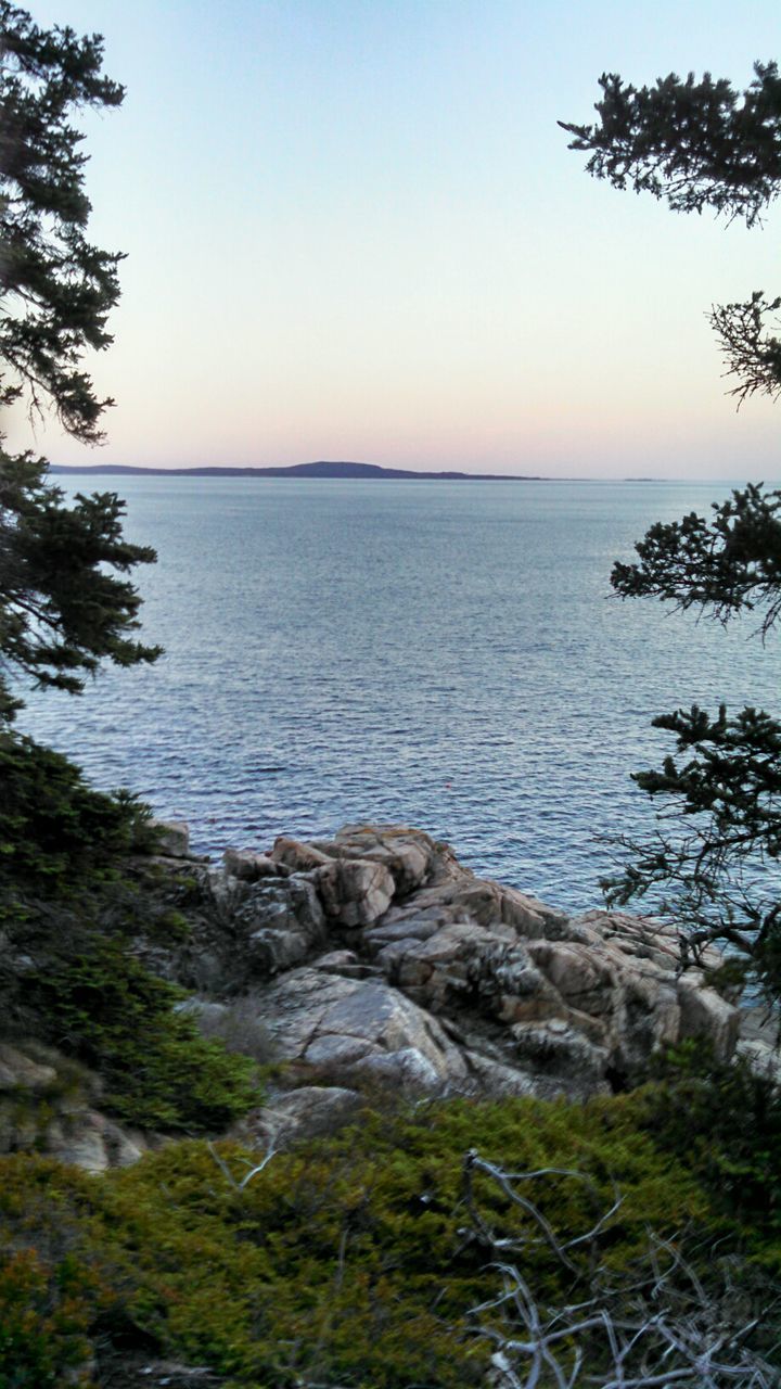 DISTANT VIEW OF SEA AGAINST CLEAR SKY