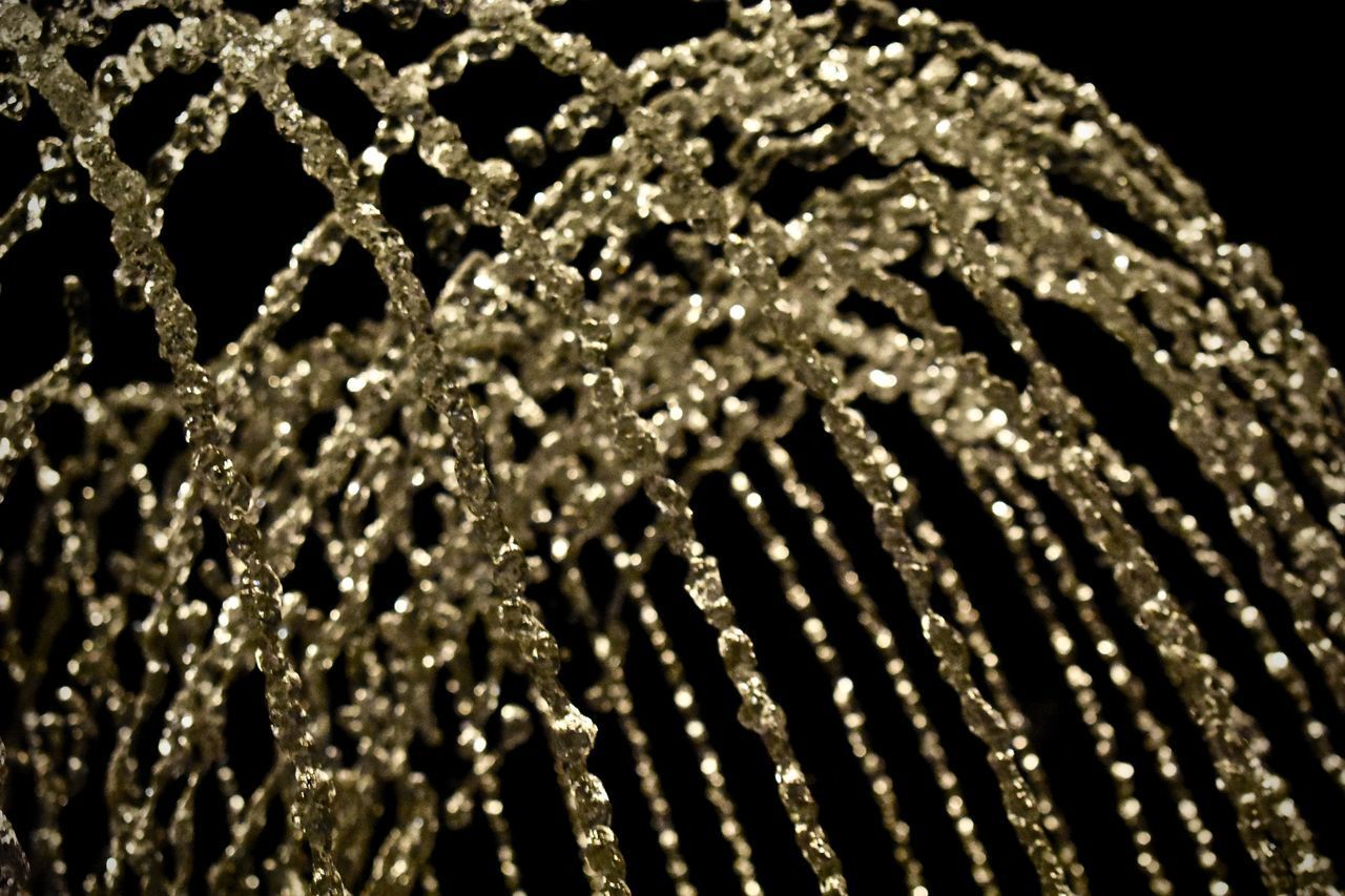 CLOSE-UP OF WATER DROP ON BLACK BACKGROUND