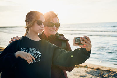 Happy women making video call on smartphone during trip on summer vacation. taking selfie photos