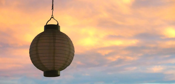 Low angle view of communications tower against sky during sunset