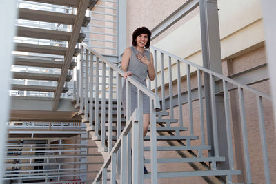 Portrait of woman standing on staircase