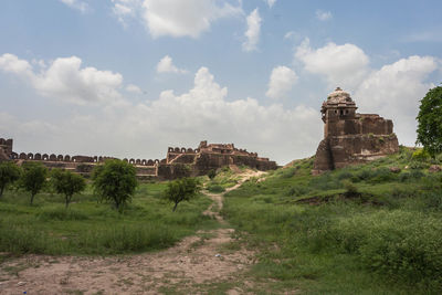 Old ruin building on landscape against sky