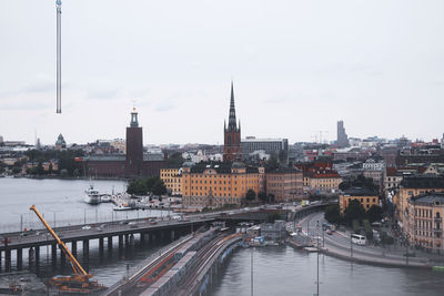 River amidst buildings in city against sky