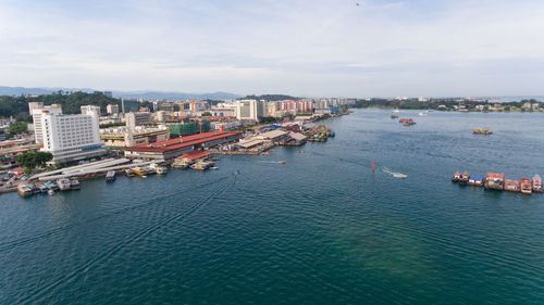 High angle view of sea and buildings against sky