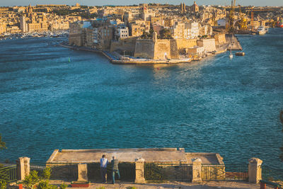 High angle view of cityscape by sea