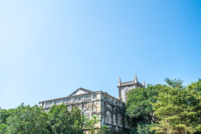 Low angle view of building against clear blue sky