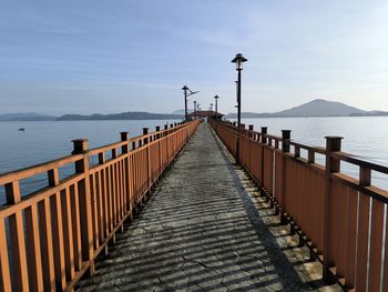 Pier over sea against sky