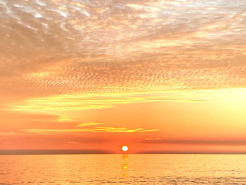 Scenic view of sea against romantic sky at sunset