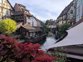 Canal amidst buildings against sky