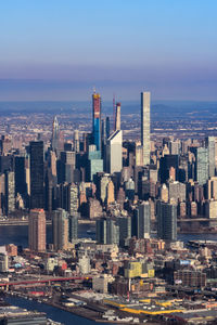 Aerial view of buildings in city against sky