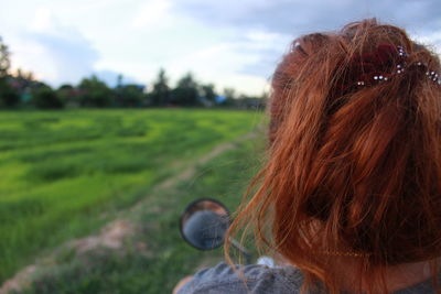 Rear view of woman on field