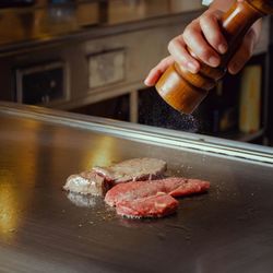 Cropped hand of person preparing food on table