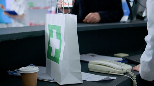 Midsection of woman with text on table