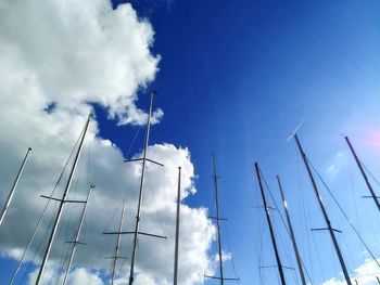 Low angle view of sailboat masts against sky