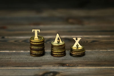 Close-up of stack coins with tax letters on table