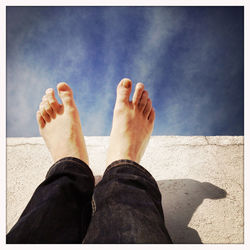 Low section of woman standing on tiled floor