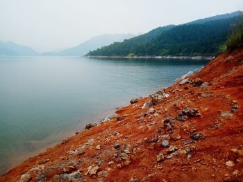 Scenic view of lake and mountains against sky