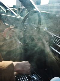 Man smoking cigarette in car