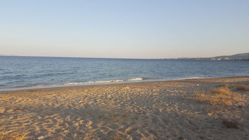 Scenic view of beach against clear sky