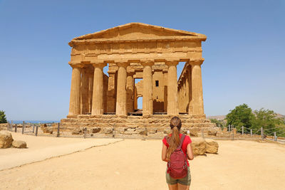 Woman standing at historical building