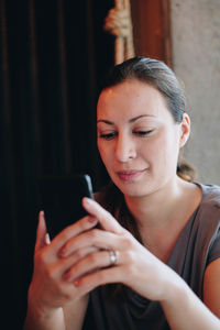 Woman using mobile phone in home