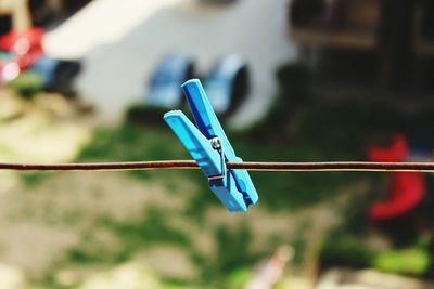 Close-up of peg on washing line against blurred background