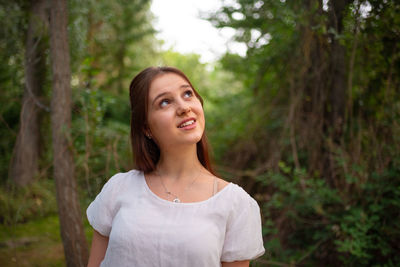 Portrait of a smiling young woman in forest