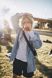 Midsection of woman standing on field