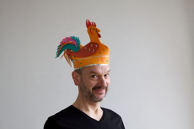 Portrait of man wearing hat against wall